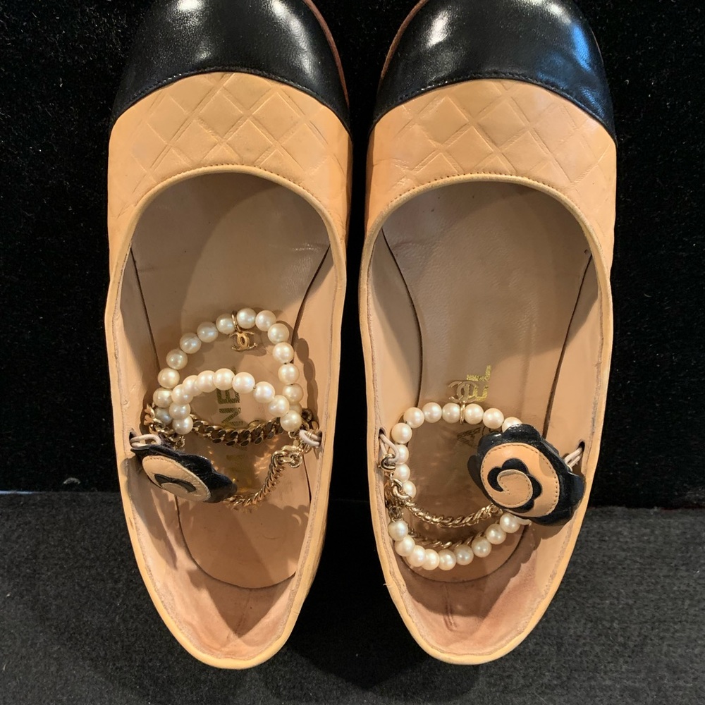Chanel beige and black flats with pearls and CC . charm